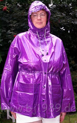 A5SPPC014edt.JPG - Glänzende lila Regenjacke mit schnürbarer Kapuze. Hoch mit Druckknöpfen zu schliessen.